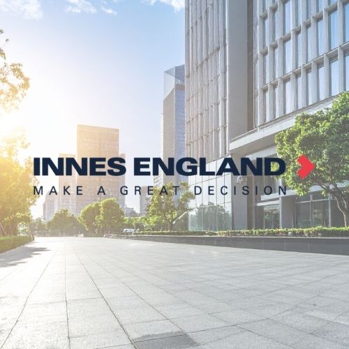 High rise offices in the sun with the words Innes England on it