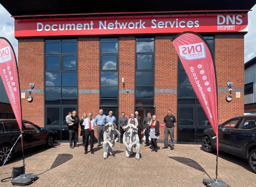 DNS Team stood outside the DNS building