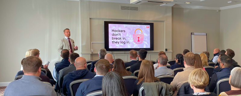 Hugh presenting cyber security training to a room of people