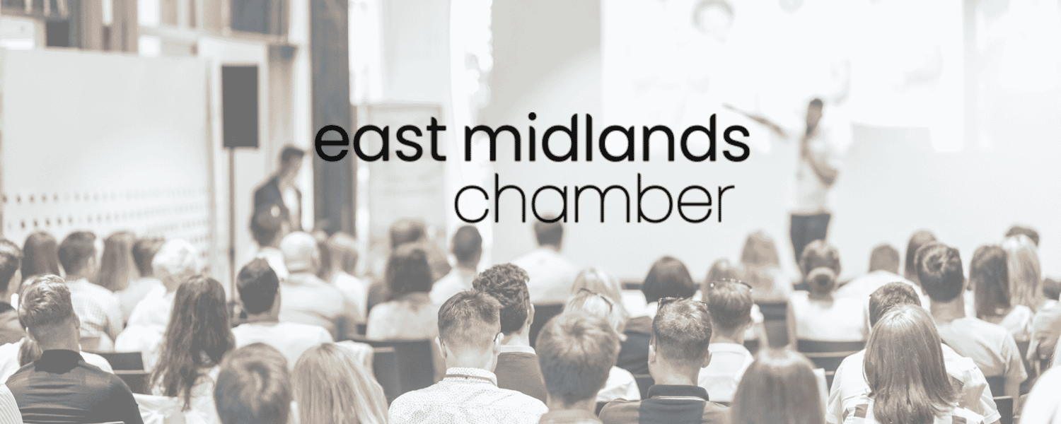 A room full of people watching a presentation with the words East Midlands Chamber over the image