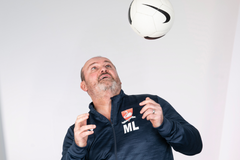 Team member heading a football